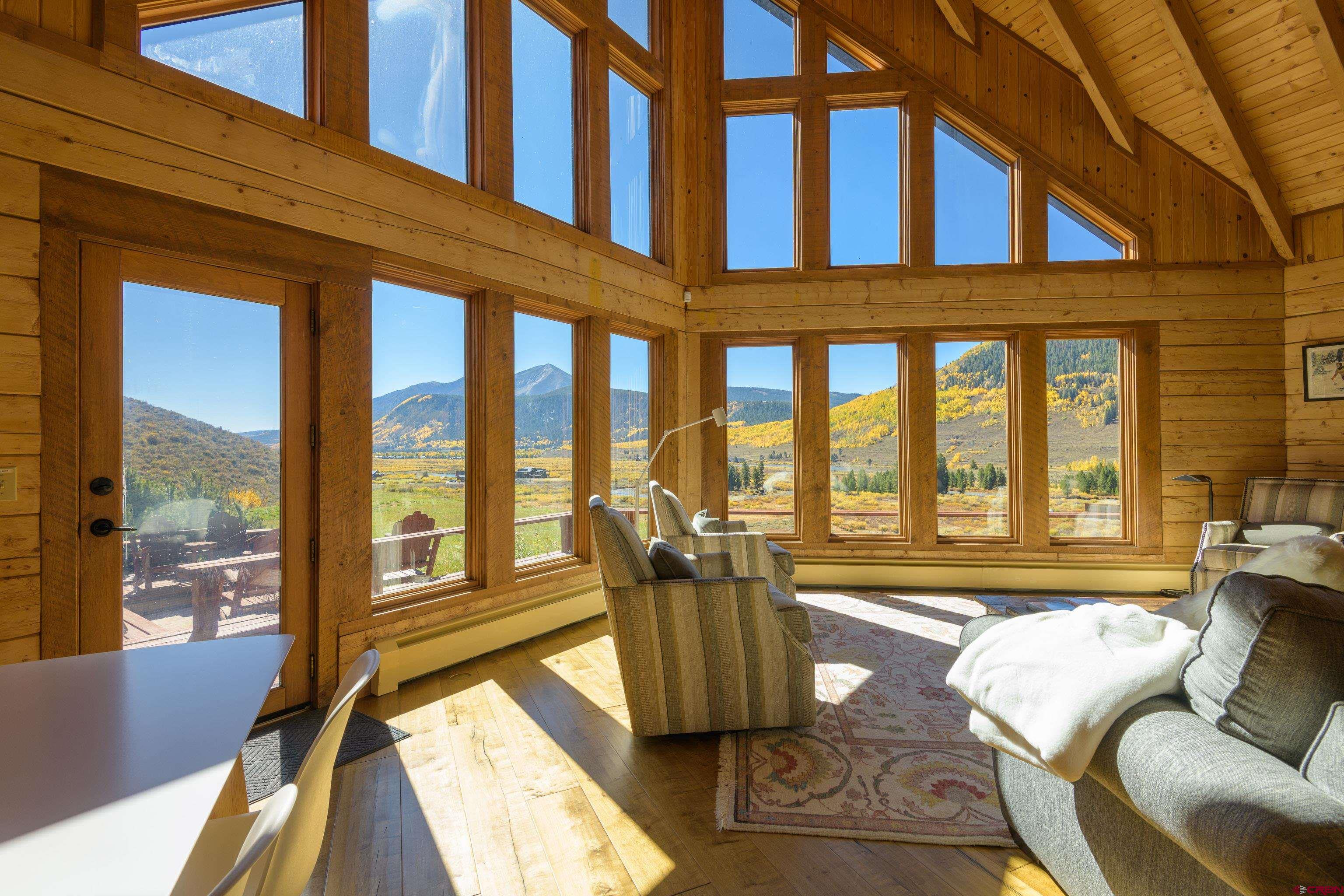 1250 County Road 734 Crested Butte, CO 81224 - Photo 15 of 45 a living room filled with furniture and floor to ceiling windows