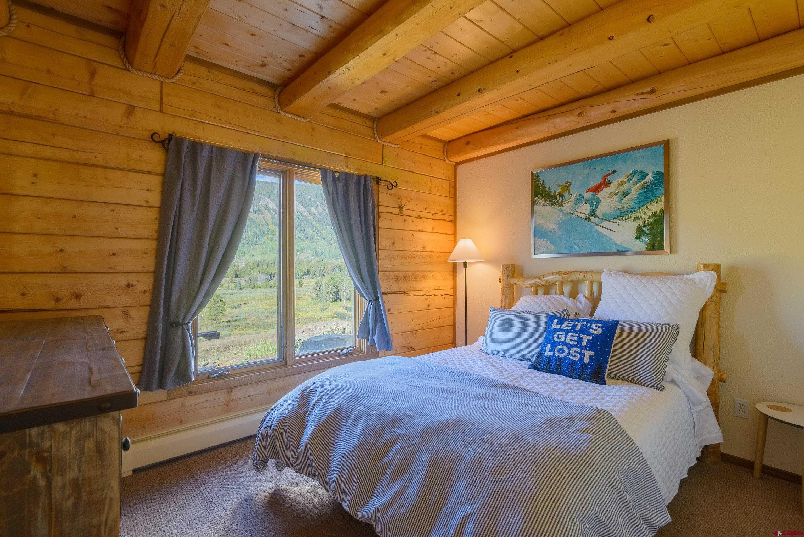 1250 County Road 734 Crested Butte, CO 81224 - Photo 19 of 45 a bedroom with a bed and a large window