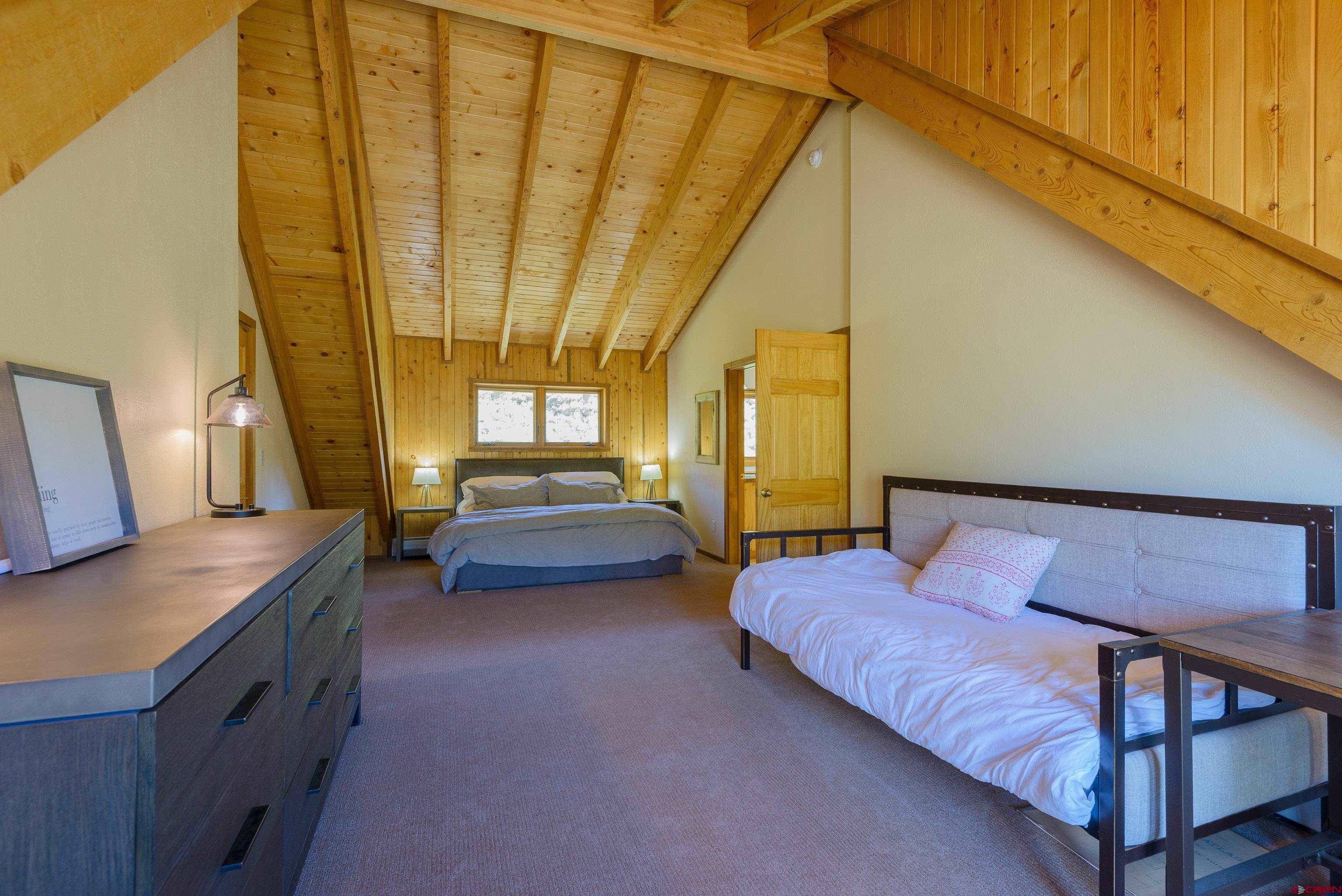 1250 County Road 734 Crested Butte, CO 81224 - Photo 29 of 45 a bedroom with a bed and a table