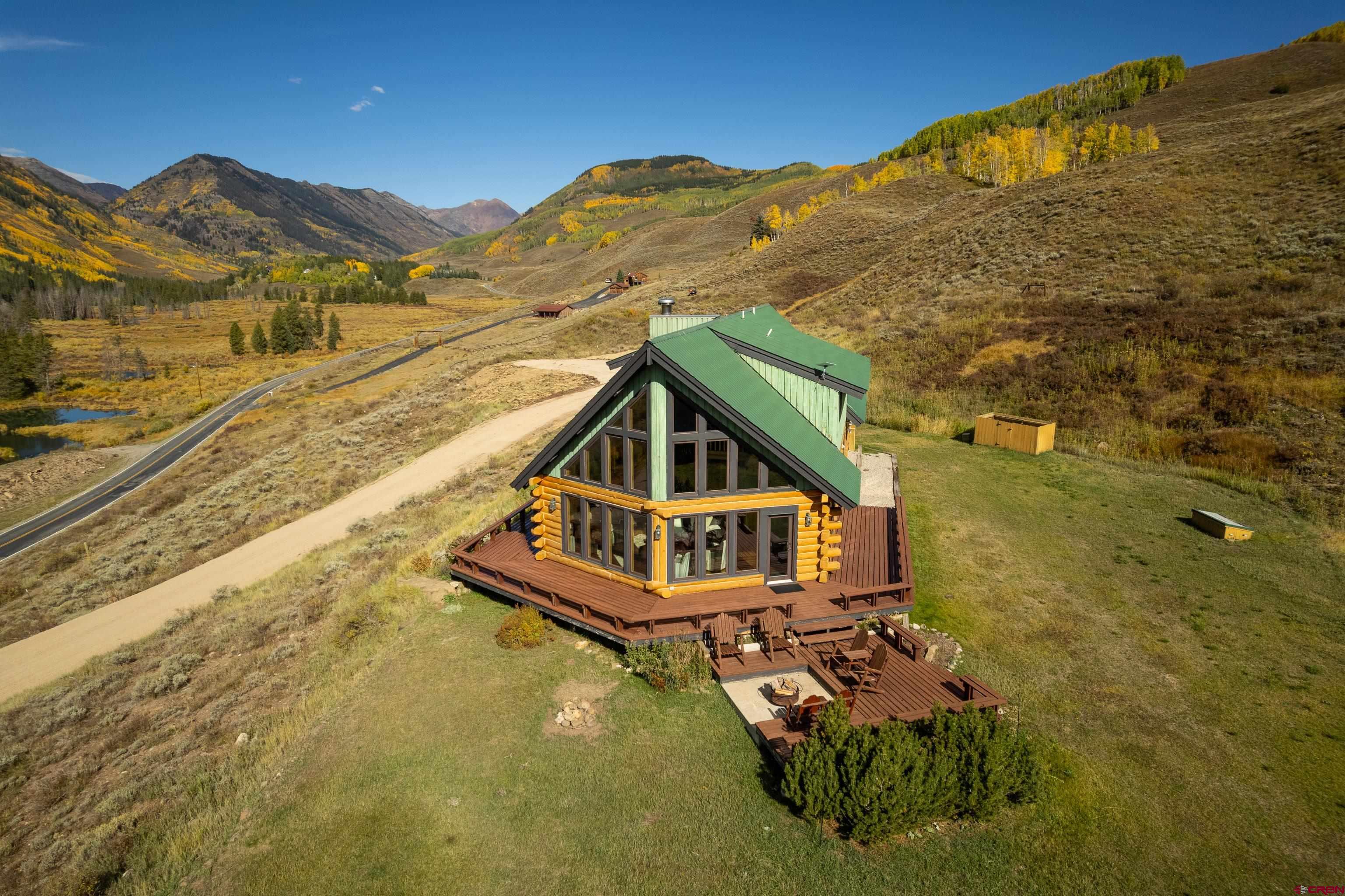 1250 County Road 734 Crested Butte, CO 81224 - Photo 3 of 45 a view of a small house with a mountain