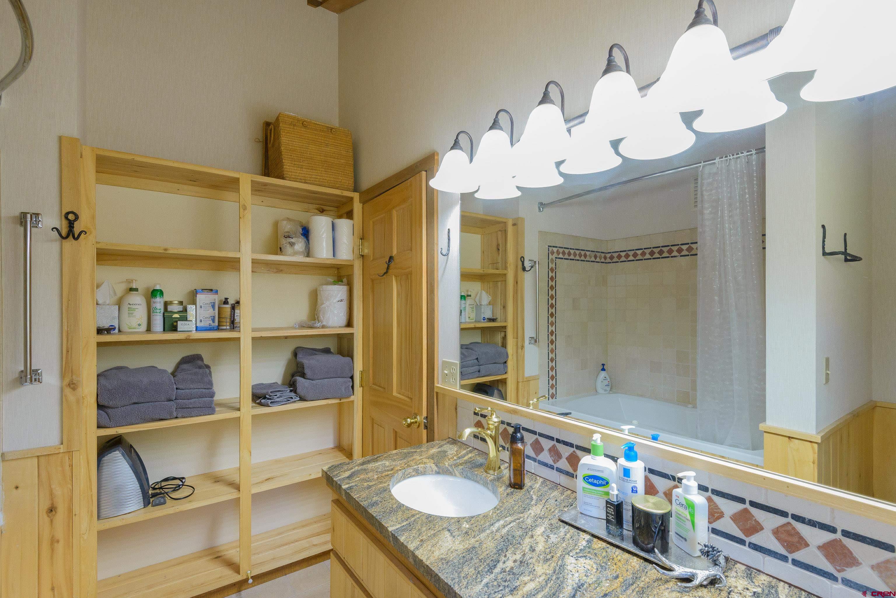 1250 County Road 734 Crested Butte, CO 81224 - Photo 31 of 45 a bathroom with a sink mirror and vanity