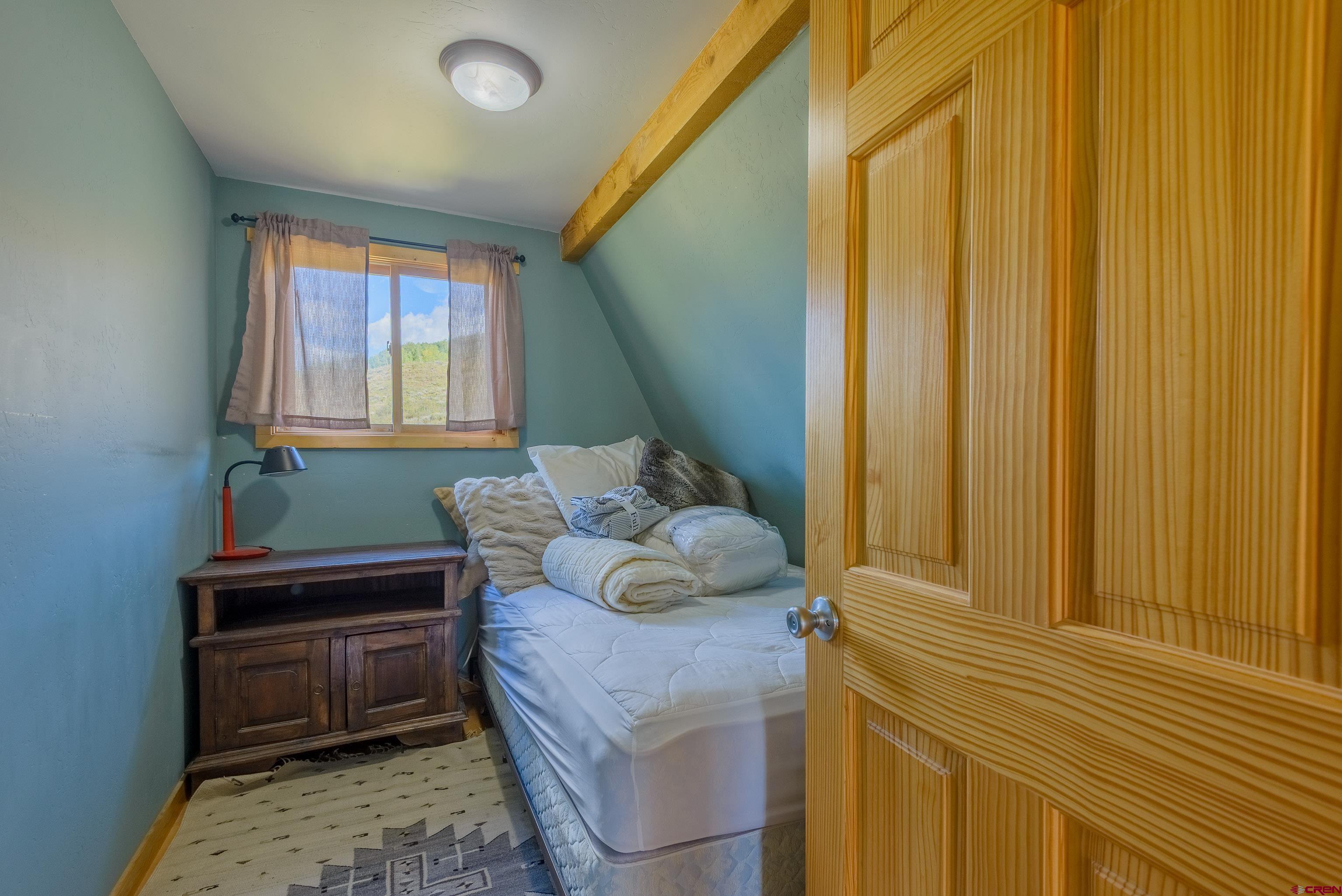 1250 County Road 734 Crested Butte, CO 81224 - Photo 37 of 45 a bedroom with a bed and a window