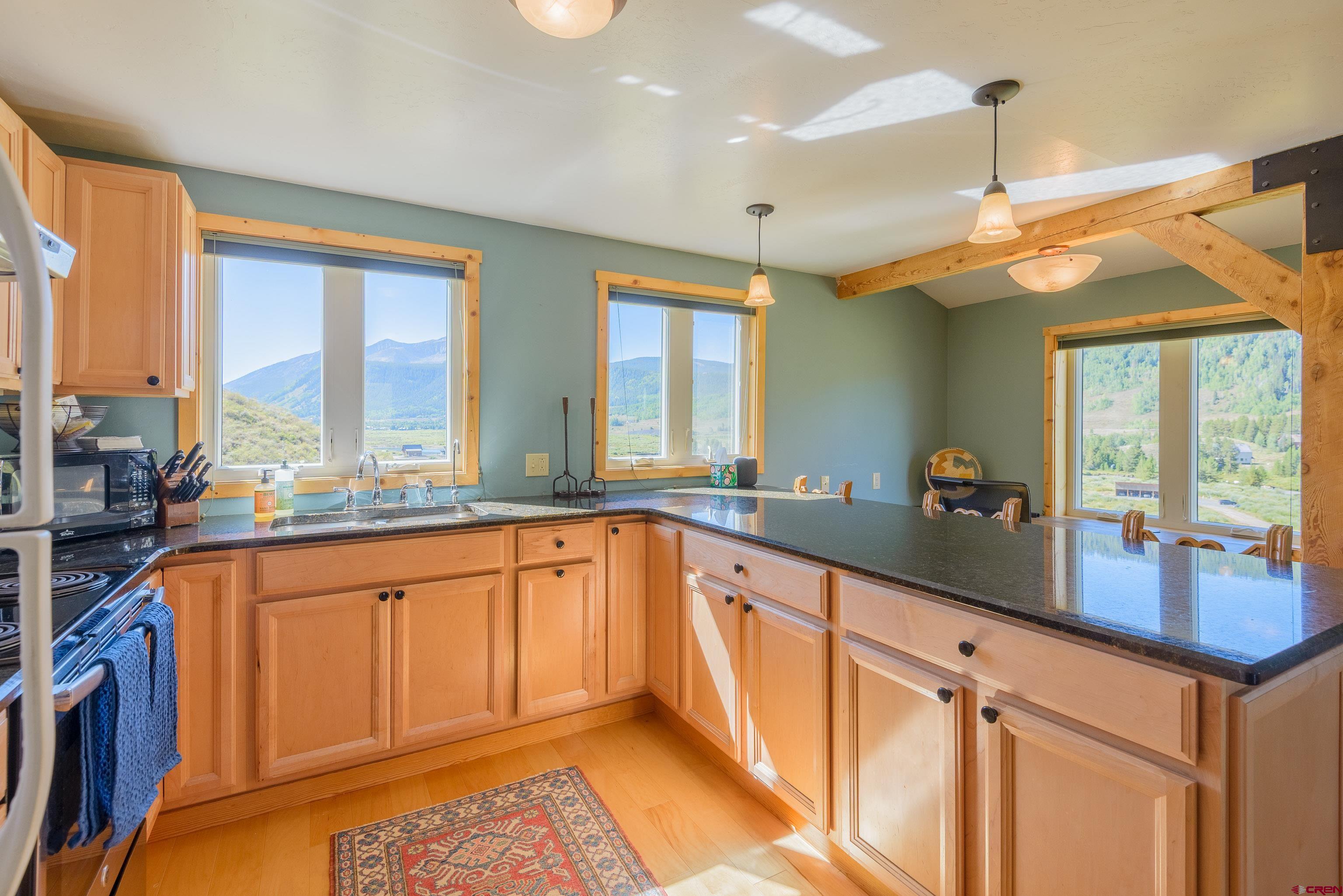 1250 County Road 734 Crested Butte, CO 81224 - Photo 40 of 45 a large kitchen with kitchen island granite countertop a large window