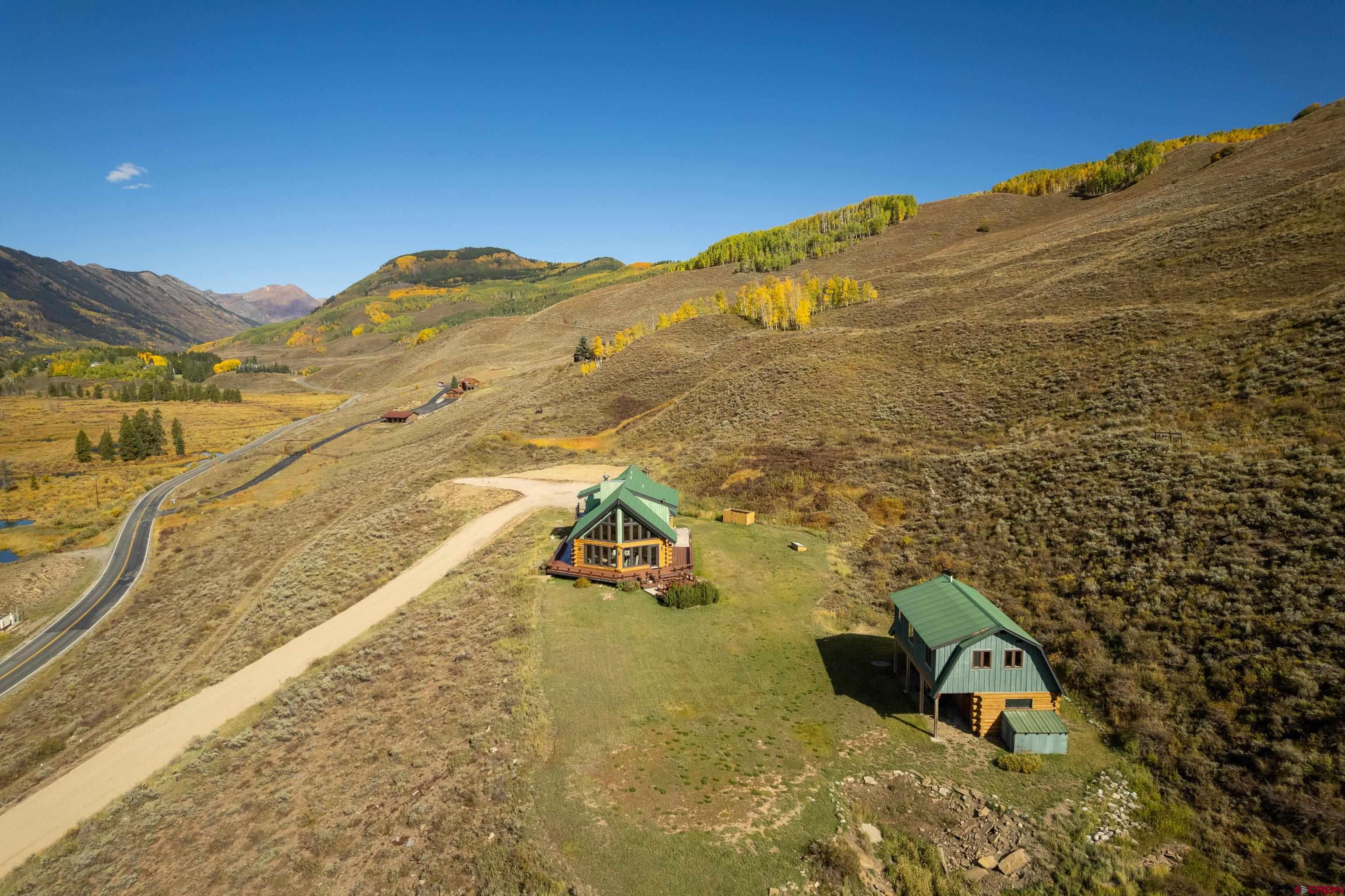 1250 County Road 734 Crested Butte, CO 81224 - Photo 6 of 45 a view of a large building with mountains in the background