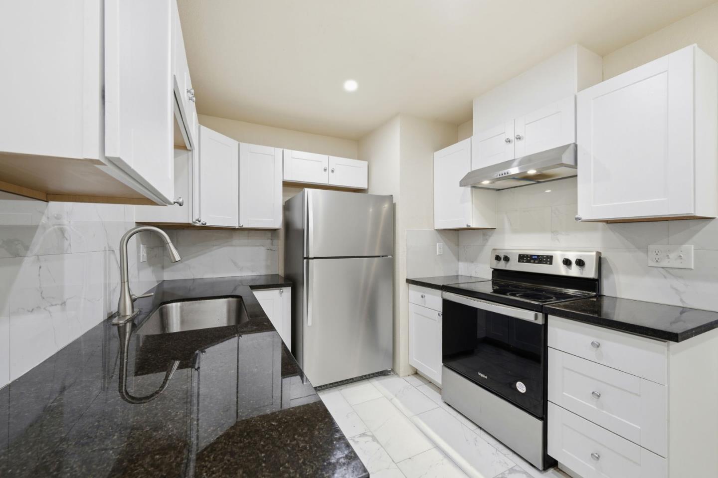 7283 Florin Road, Unit 8 Sacramento, CA 95828 - Photo 14 of 35 a kitchen with a stove a refrigerator and cabinets
