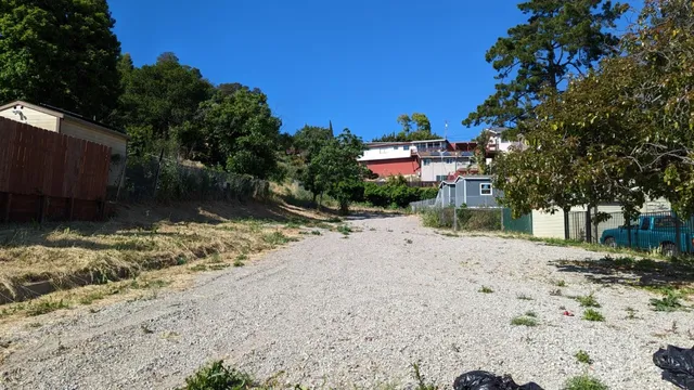 a view of a road with a trees in the background