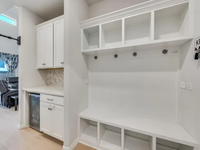 a kitchen with white cabinets and a stove