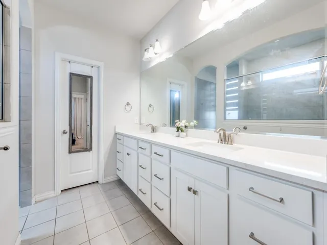 a spacious bathroom with a double vanity sink mirror and