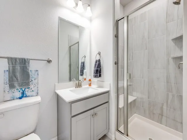 a bathroom with a sink toilet and shower
