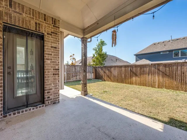 a view of a backyard with wooden fence