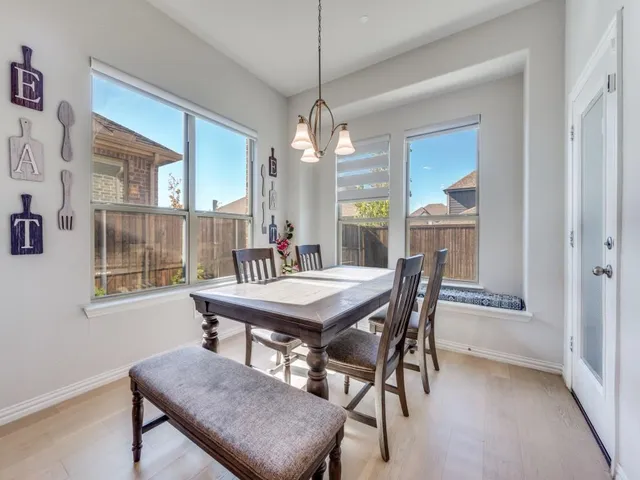 a dining room with furniture and window