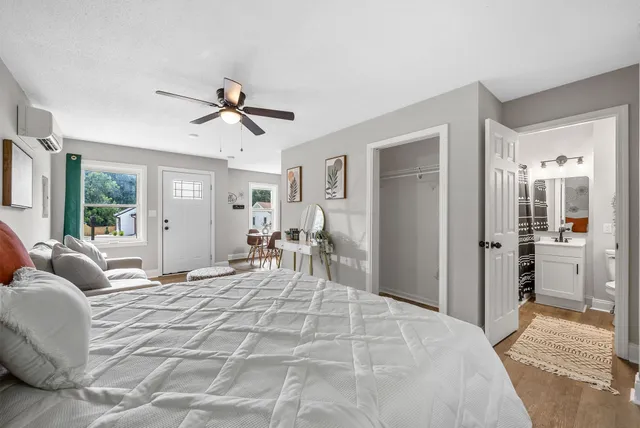 a bedroom with a bed and a chandelier