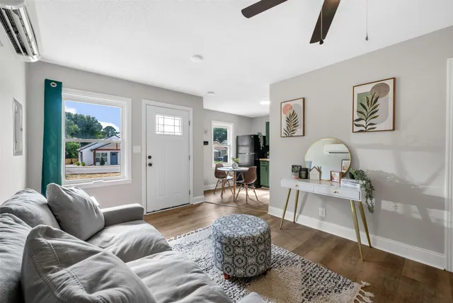 a living room with furniture and a large window