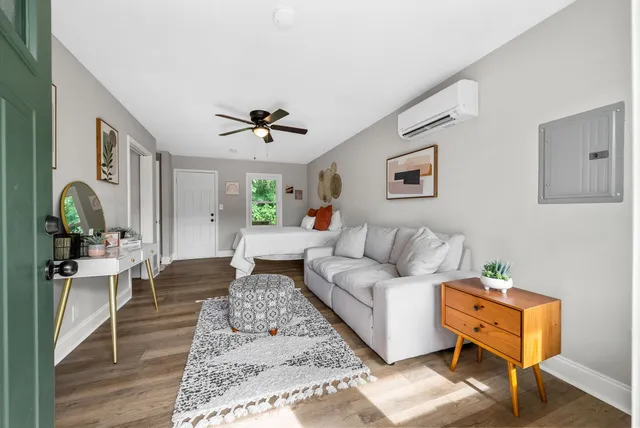 a living room with furniture and wooden floor