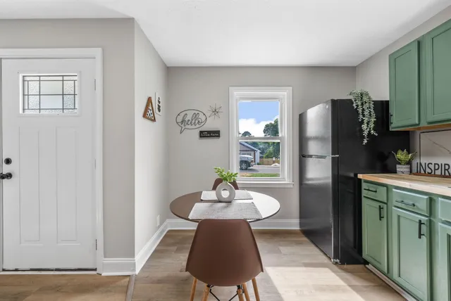 a kitchen with stainless steel appliances a refrigerator and a wooden cabinets