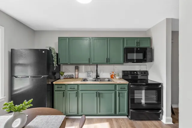 a kitchen with a sink and a refrigerator