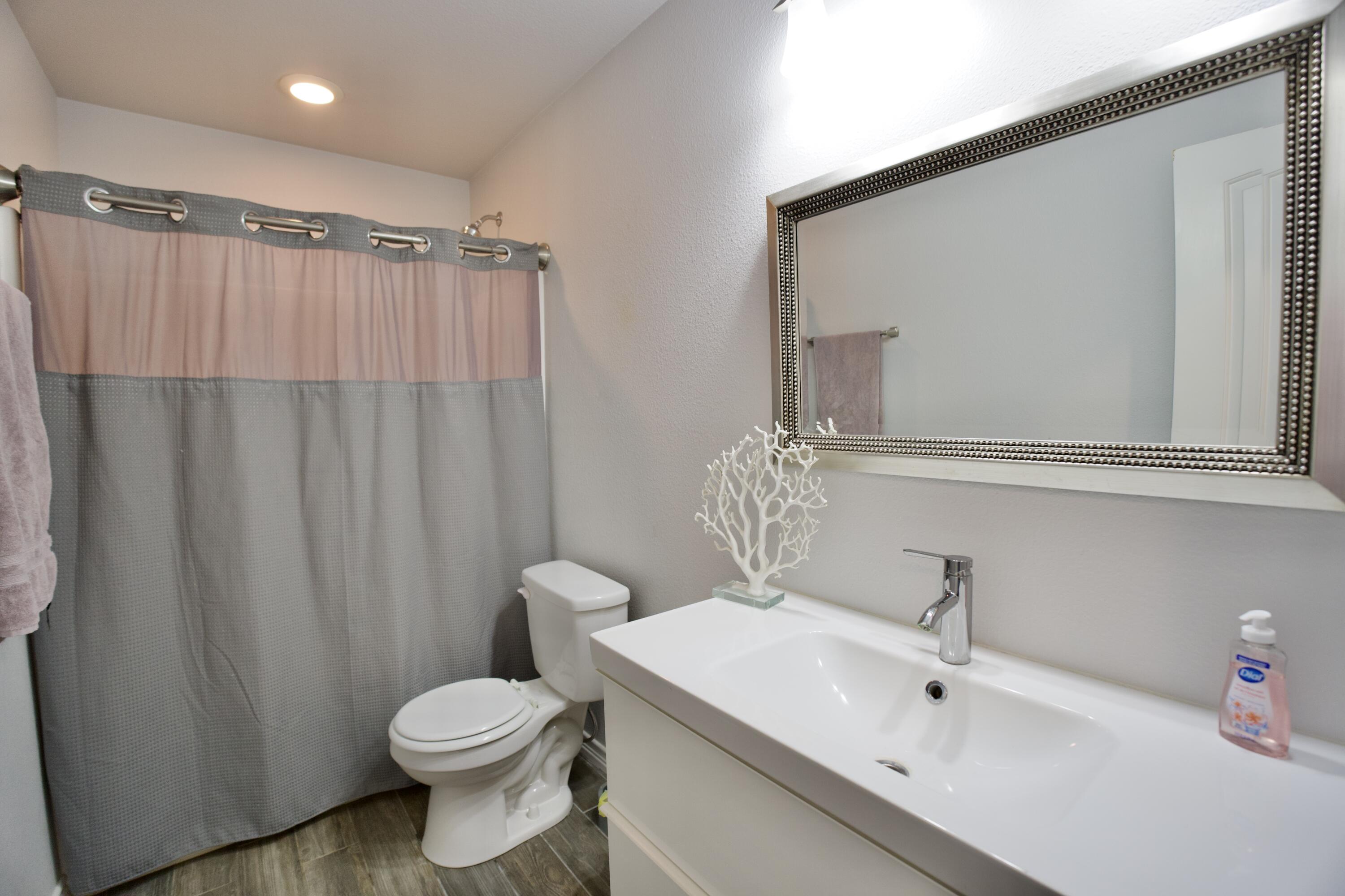 8813 17th Street Lubbock, TX 79416 - Photo 12 of 20 a bathroom with a sink a toilet and shower