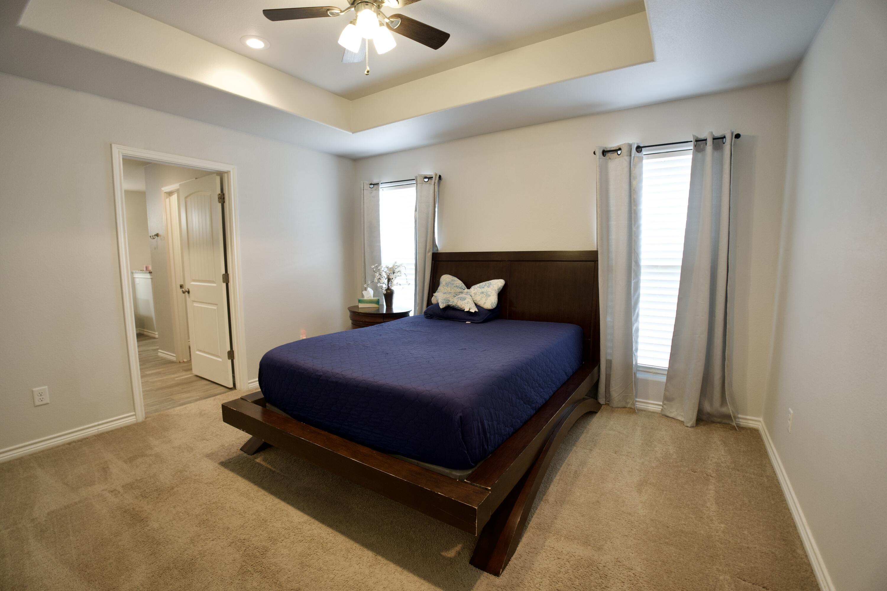 8813 17th Street Lubbock, TX 79416 - Photo 13 of 20 a bedroom with a bed and window