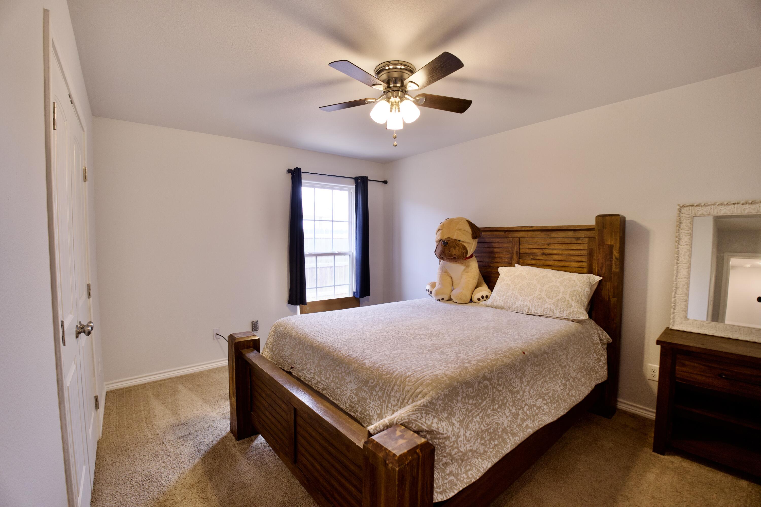 8813 17th Street Lubbock, TX 79416 - Photo 18 of 20 a bedroom with a bed and window