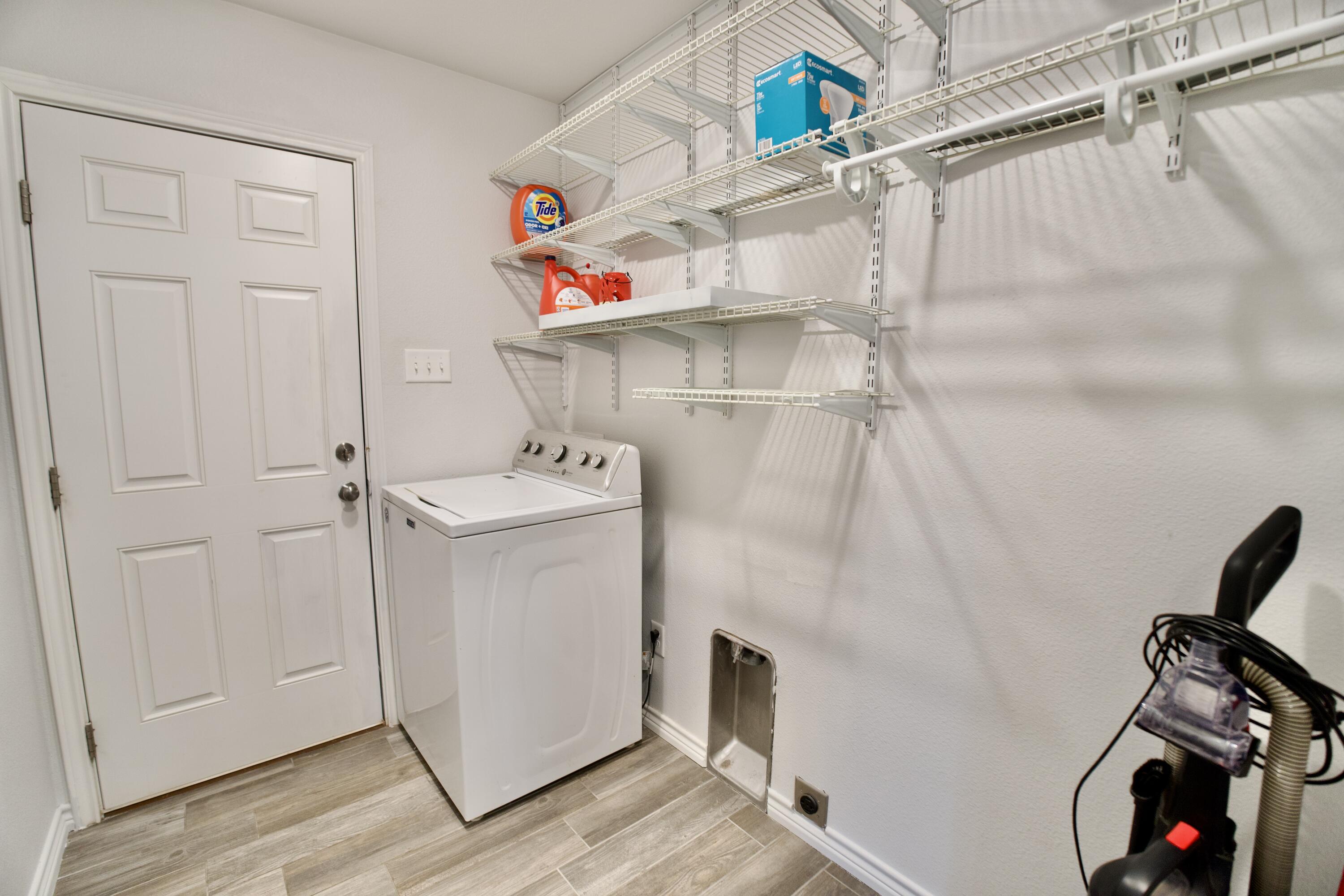 8813 17th Street Lubbock, TX 79416 - Photo 20 of 20 a utility room with dryer and washer