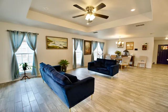 a view of a dining room with furniture and wooden floor