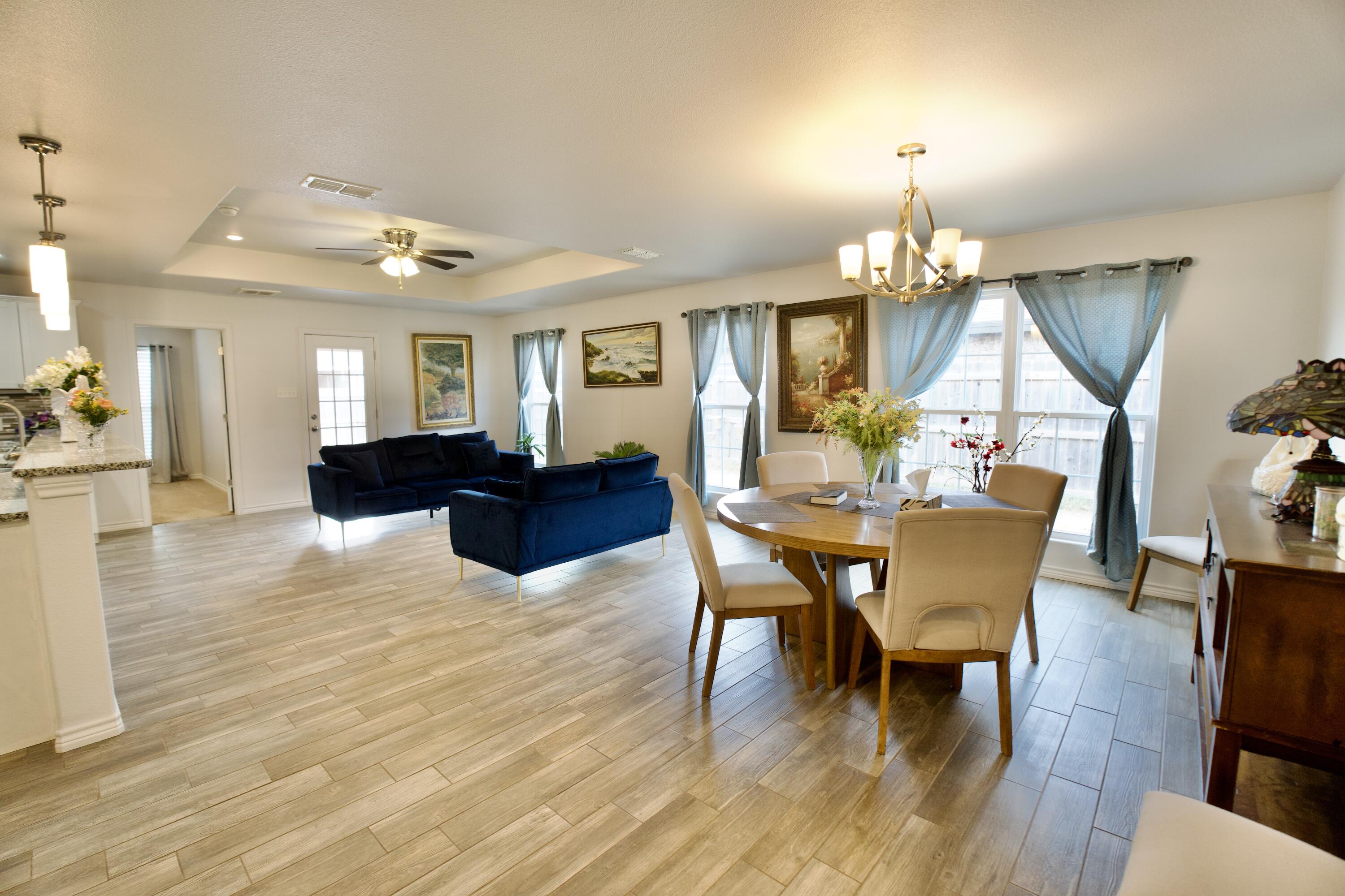8813 17th Street Lubbock, TX 79416 - Photo 5 of 20 a view of a dining room with furniture and wooden floor