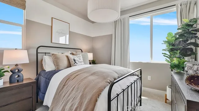 a bedroom with a bed and a potted plant