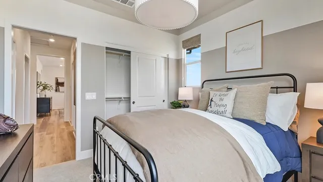 a bedroom with a bed and a chandelier