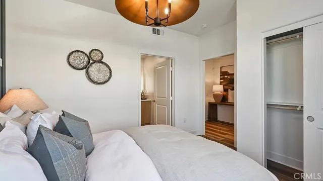 a bedroom with a bed and a chandelier