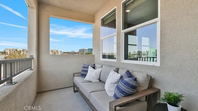 a balcony with furniture and a potted plant