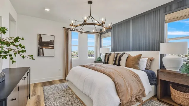 a bedroom with a bed and a chandelier