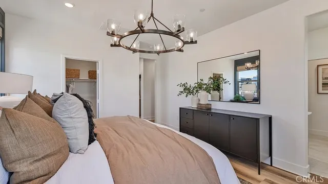 a bedroom with a bed and chandelier