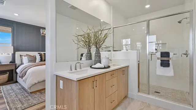 a bathroom with a double vanity sink a mirror and shower