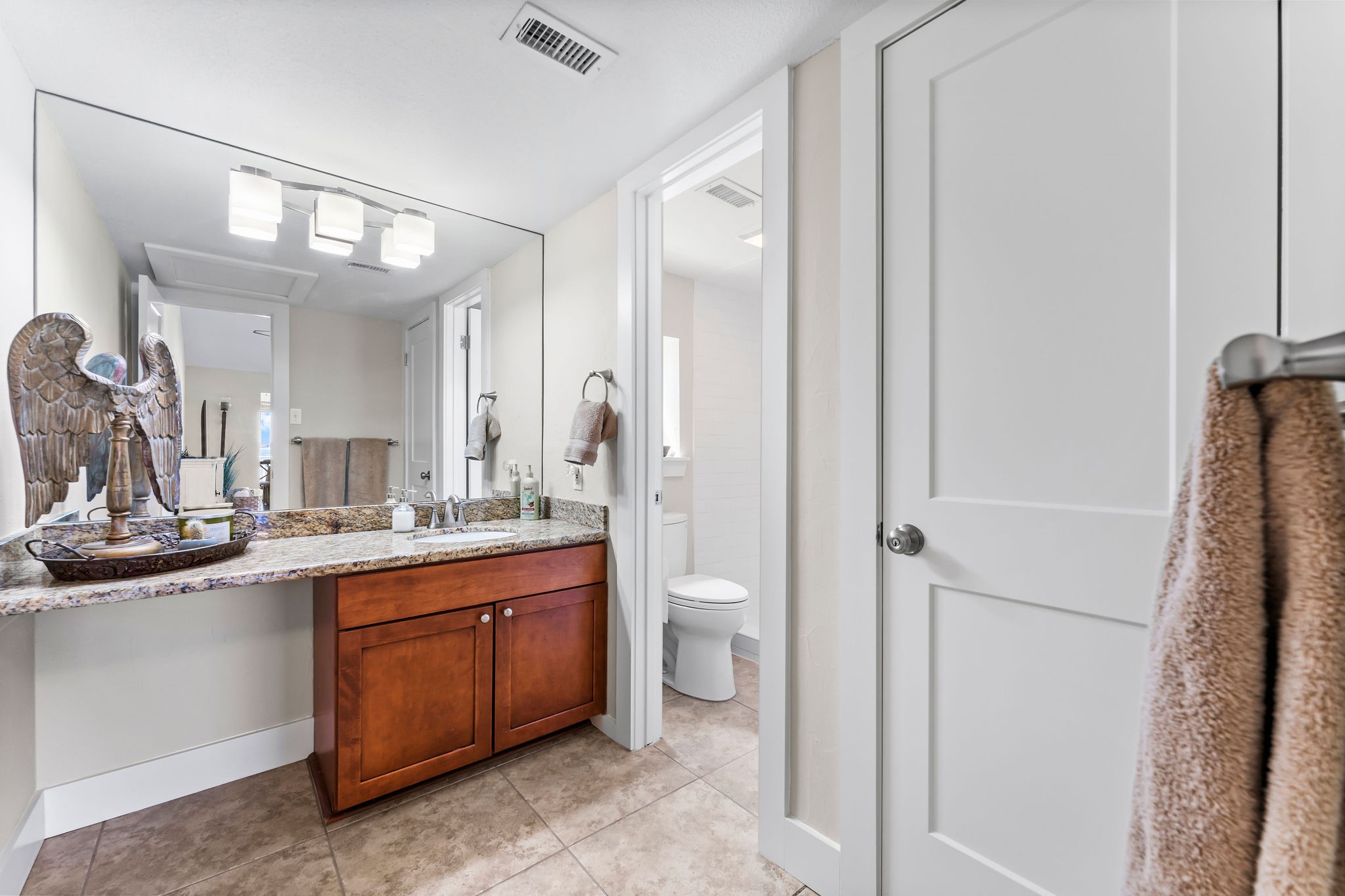 69 Lakeview Village Conroe, TX 77356 - Photo 29 of 50 a bathroom with a double vanity sink and a mirror