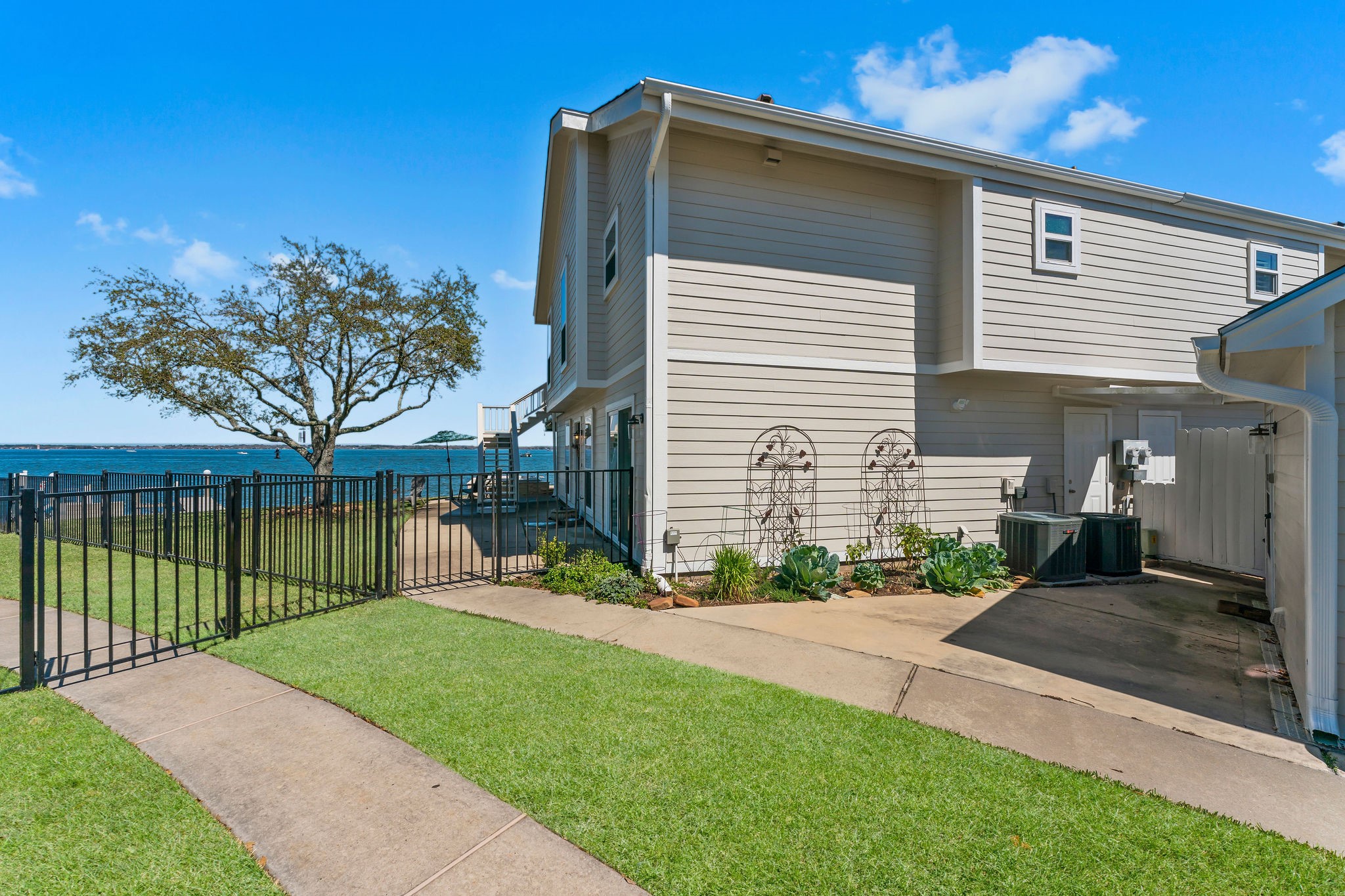 69 Lakeview Village Conroe, TX 77356 - Photo 4 of 50 a front view of a house with a garden and yard
