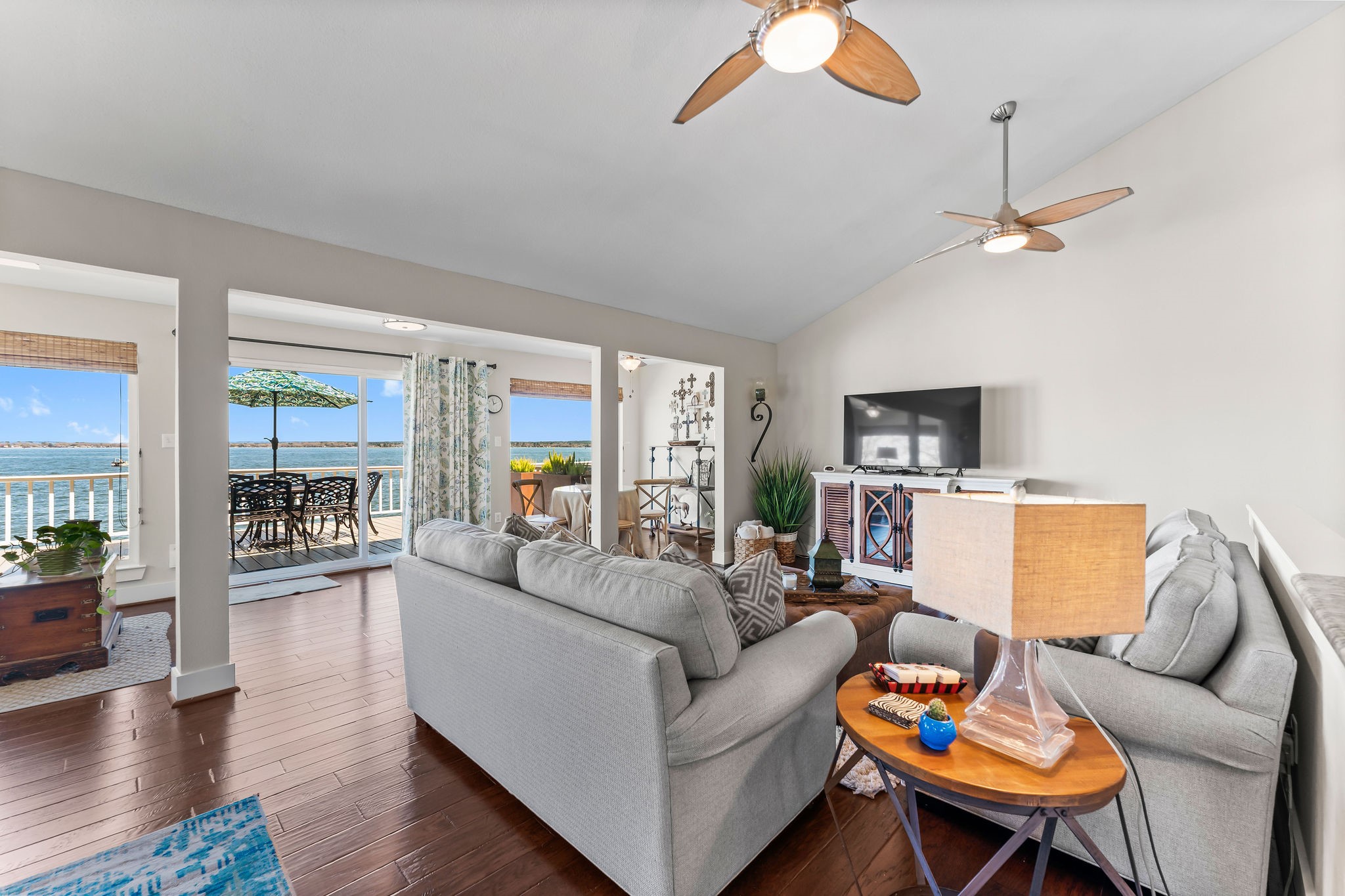 69 Lakeview Village Conroe, TX 77356 - Photo 7 of 50 a living room with furniture a ceiling fan and a rug
