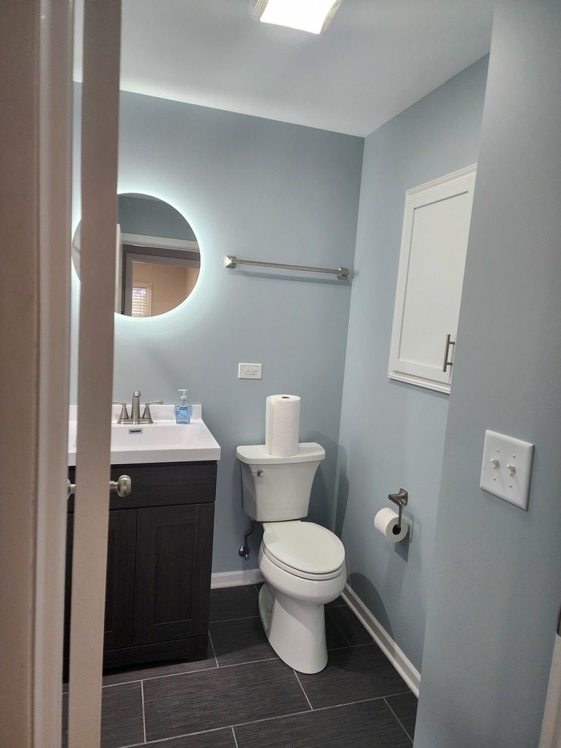 45 Arrowhead Drive Thornton, IL 60476 - Photo 6 of 11 a bathroom with a toilet sink and mirror