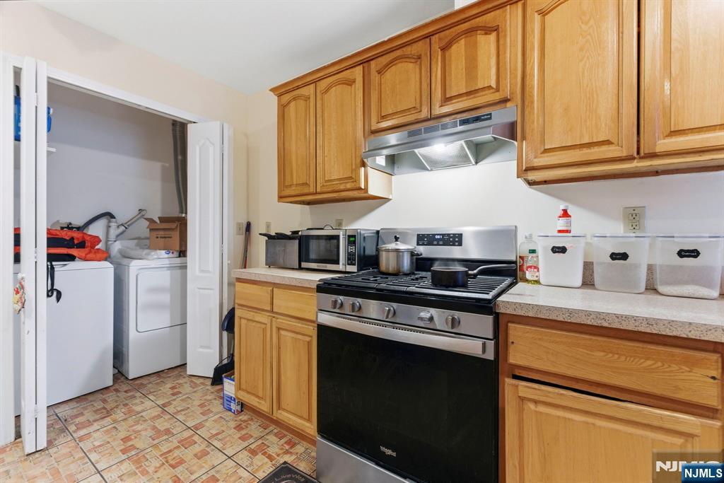 29-31 22nd Avenue Paterson, NJ 07513 - Photo 11 of 20 a kitchen with stainless steel appliances granite countertop a stove and a refrigerator