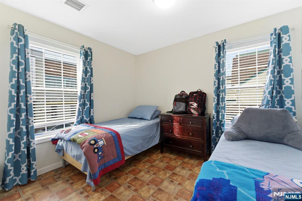 29-31 22nd Avenue Paterson, NJ 07513 - Photo 12 of 20 a bedroom with a bed and a window