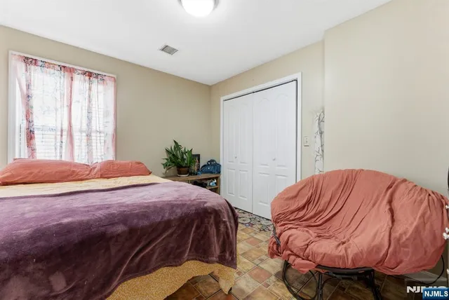 a bedroom with a bed and closet