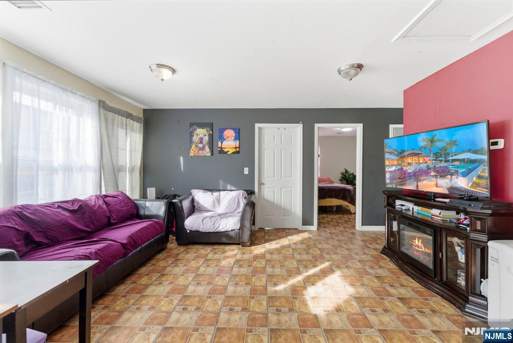 29-31 22nd Avenue Paterson, NJ 07513 - Photo 15 of 20 a living room with furniture and a flat screen tv