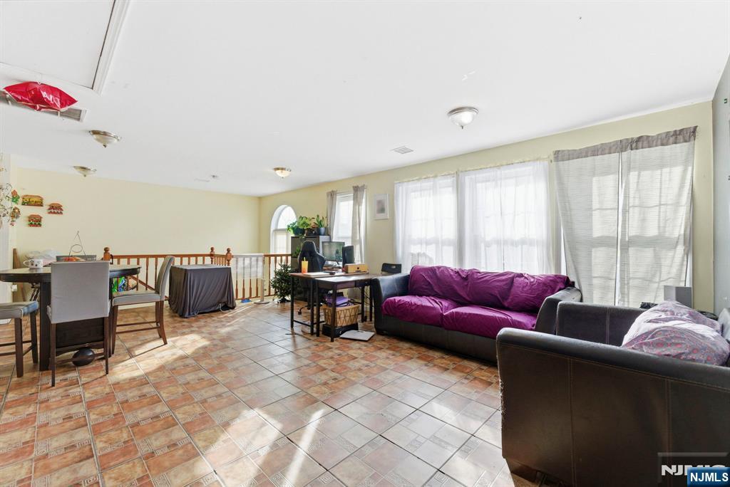 29-31 22nd Avenue Paterson, NJ 07513 - Photo 17 of 20 a living room with furniture and a window