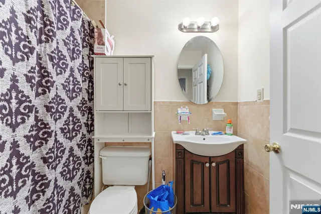 a bathroom with a sink and a mirror with toilet