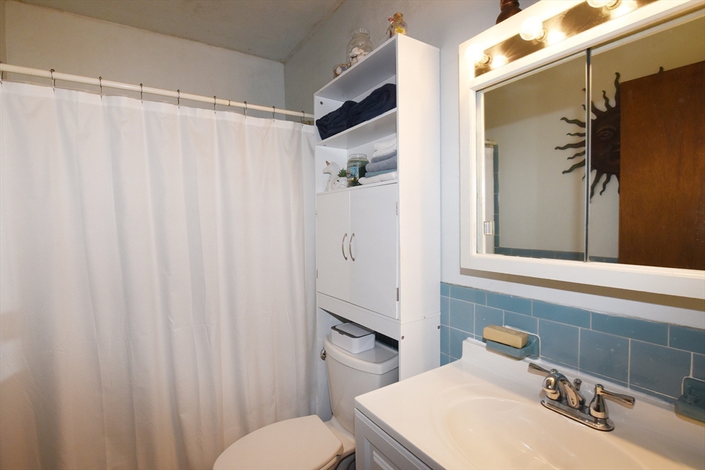 980 Plain Street, Unit 4 Marshfield, MA 02050 - Photo 17 of 26 a bathroom with a sink toilet and shower