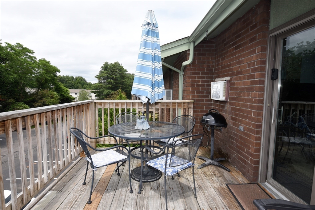 980 Plain Street, Unit 4 Marshfield, MA 02050 - Photo 24 of 26 a view of a chair and table on the deck