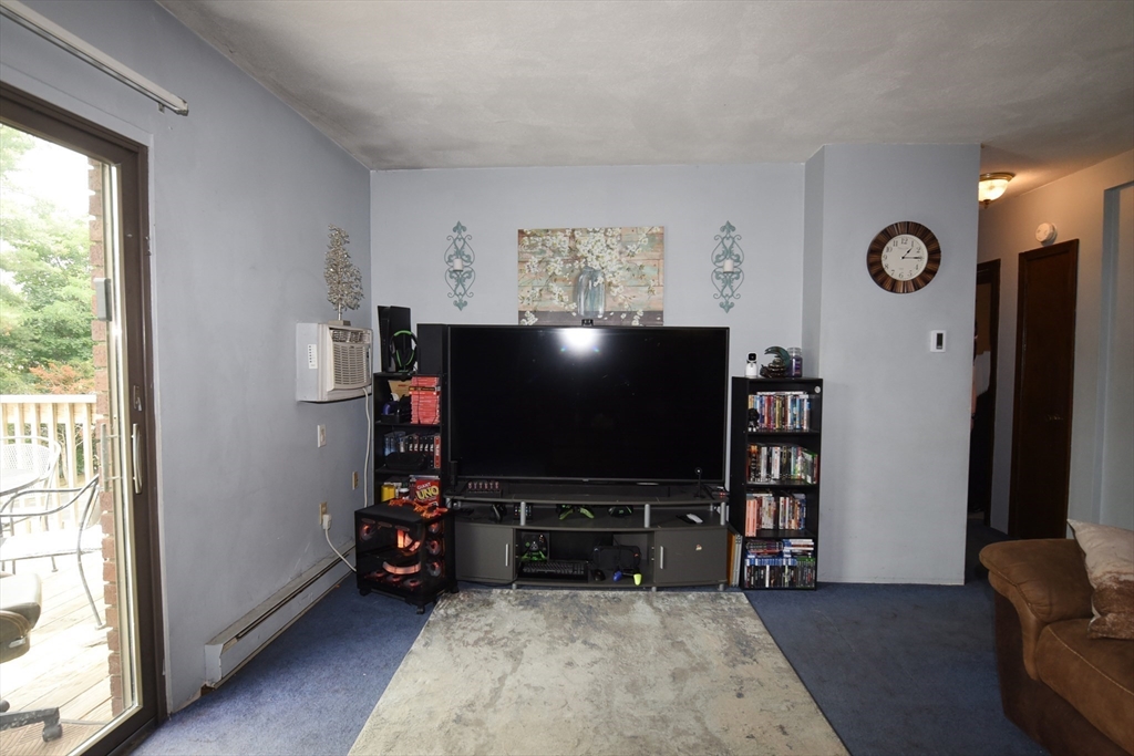 980 Plain Street, Unit 4 Marshfield, MA 02050 - Photo 7 of 26 a living room with furniture and a flat screen tv