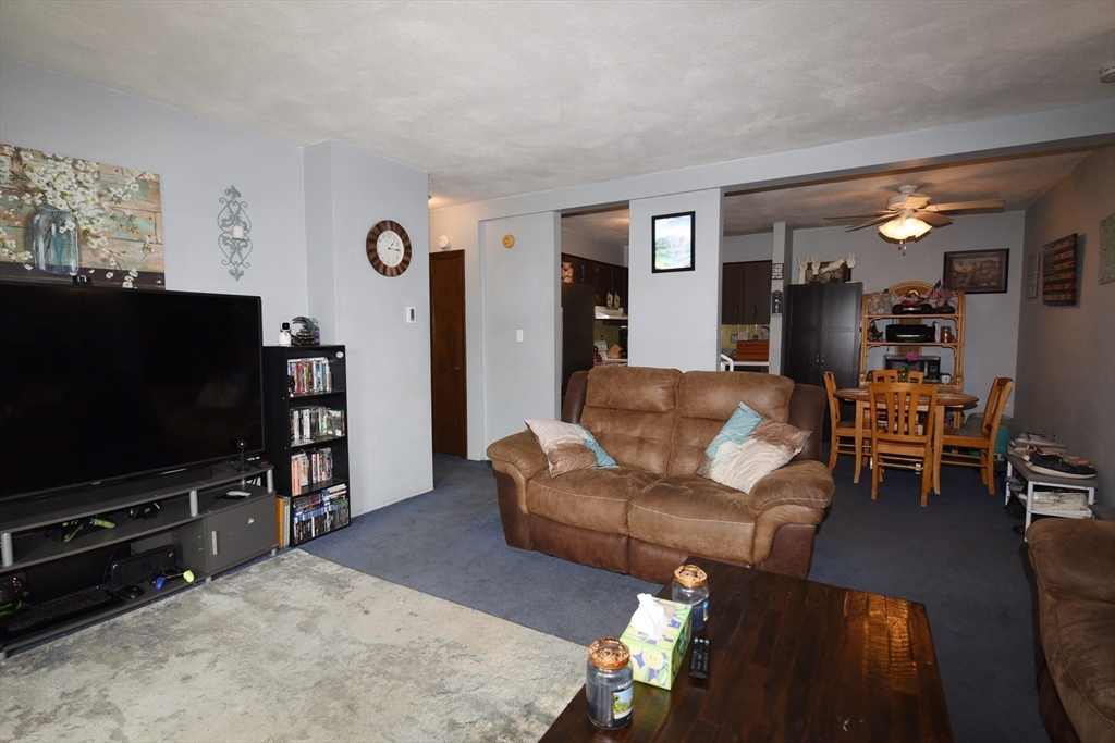 980 Plain Street, Unit 4 Marshfield, MA 02050 - Photo 8 of 26 a living room with furniture and a flat screen tv