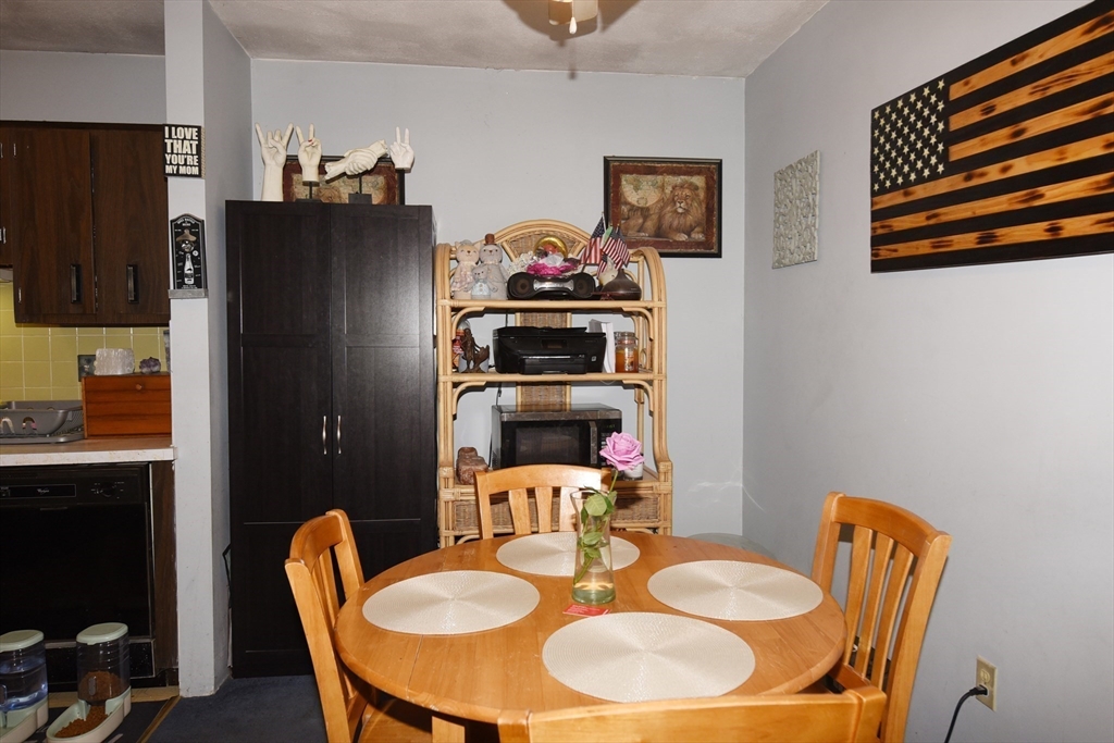 980 Plain Street, Unit 4 Marshfield, MA 02050 - Photo 9 of 26 a dining room with furniture and a refrigerator