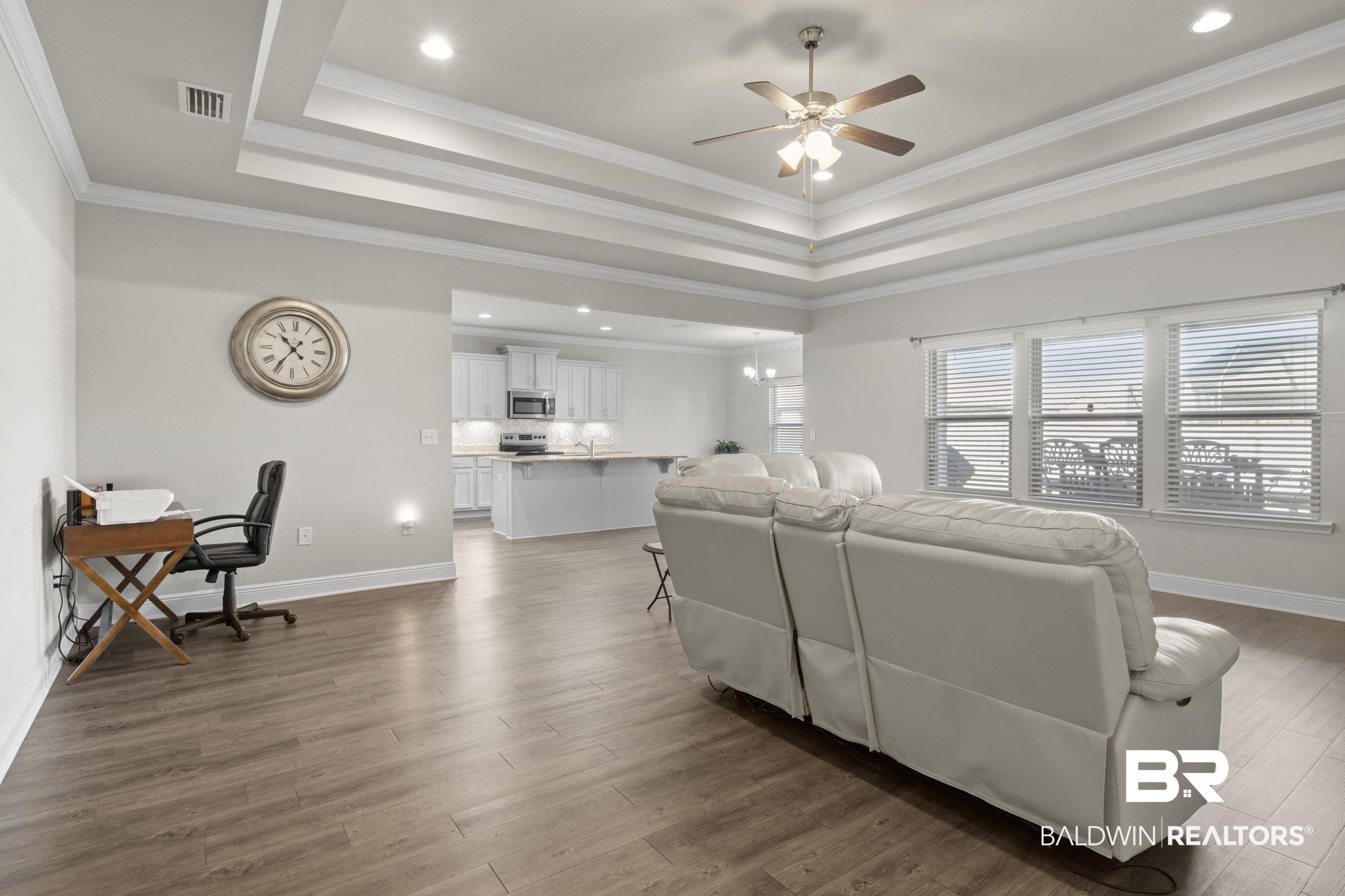 2050 Bourbon Street Foley, AL 36535 - Photo 10 of 32 Living room featuring a tray ceiling, ceiling fan, dark hardwood / wood-style flooring, and ornamental molding