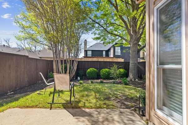 a patio with a yard table and chairs